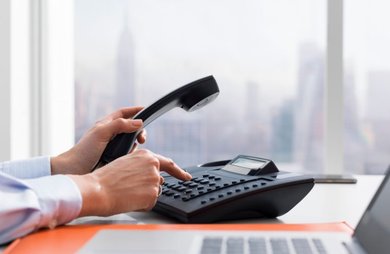 female-office-worker-making-a-phone-call-5X48PM3